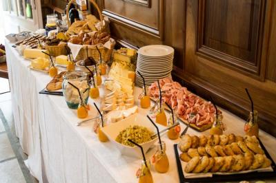 Traiteur Frederic Fouquet Créateur d'Emotions Culinaires Faverges #5 Table garnie de plats variés : charcuterie, fromages, pains, viennoiseries et jus, disposés pour un buffet.