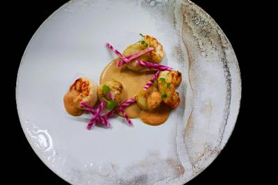 Traiteur Niel Traiteur Le Lion-d'Angers #4 Assiette gastronomique avec crevettes, sauce crémeuse et garniture de légumes colorés sur une présentation soignée.